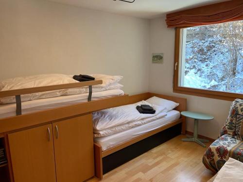 a room with two bunk beds and a window at Spacious apartment up to 6 people in Flims in Flims