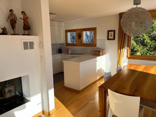 a kitchen and living room with a table and a kitchen and a dining room at Spacious apartment up to 6 people in Flims in Flims