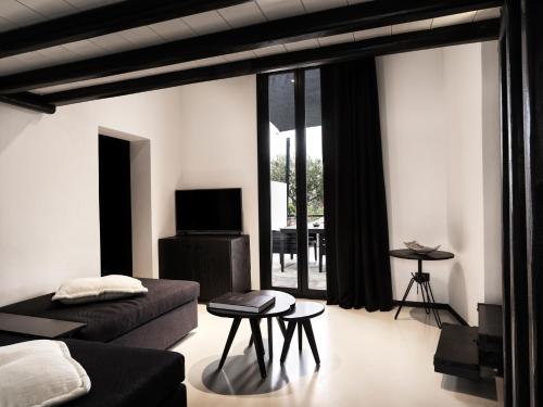 a living room with a couch and a table at Liostasi in Ios Chora