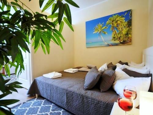 a bedroom with a large bed with palm trees at Apartment with a large terrace, close to the beach, Ustronie Morskie in Ustronie Morskie