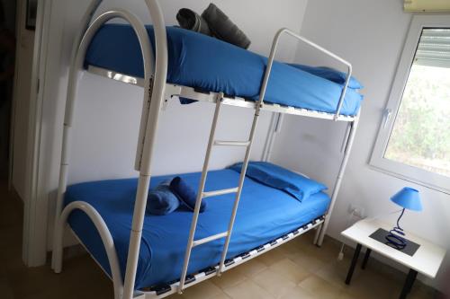 a bedroom with two bunk beds in a room at Rocca dei tramonti in Punta Braccetto
