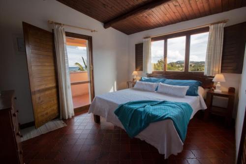 a bedroom with a large bed and a large window at Sardegna Beach Ginepro in Olbia