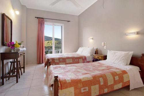 a hotel room with two beds and a window at Dolphin Studio 3 in Keri