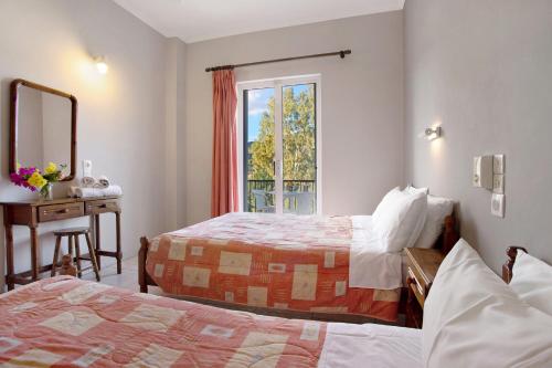 a hotel room with two beds and a window at Dolphin Studio Sea View 10 in Keri