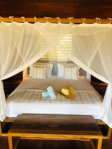 two stuffed animals sitting on top of a bed at Kabana Hotel in Prea