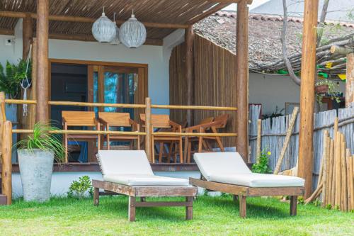 a patio with two chairs and a table at Pousada Preamar in Prea