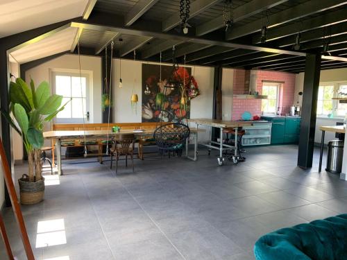 a large room with tables and chairs in it at Luxe in stiltegebied tussen loslopende Alpaca’s in Eemdijk