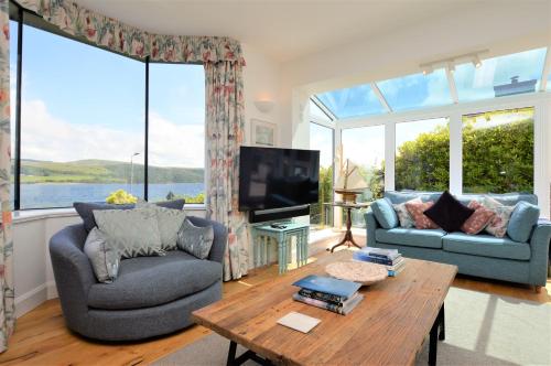 a living room with a couch and a table at The Neuk in Tighnabruaich