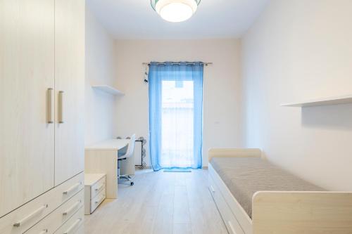 a hospital room with a bed and a desk at Casa L - Mimbelli Park Modern Quiet Apartment in Livorno