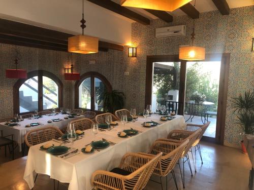 a dining room with a long table and chairs at La Almendra y El Gitano in Agua Amarga