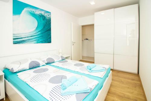 a bedroom with a bed and a painting on the wall at Luxury Apartment Luna in Vantačići
