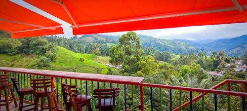 a balcony with chairs and a view of the mountains at Hotel Salento Mirador in Salento
