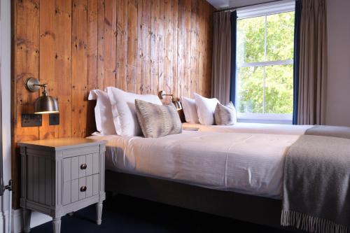 a bedroom with a large bed with a window at The Brownswood in London