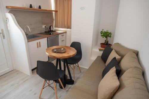 a living room with a couch and a table at Studios Alsos in Naxos Chora