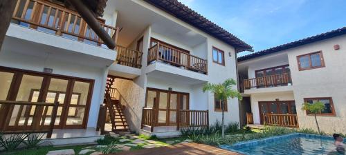 a house with a swimming pool in front of it at Barra Grande Villa Uluwatu 104 in Barra Grande