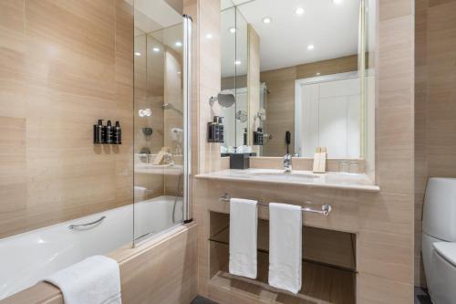 a bathroom with a shower and a sink and a toilet at Eurostars Gran Madrid in Alcobendas
