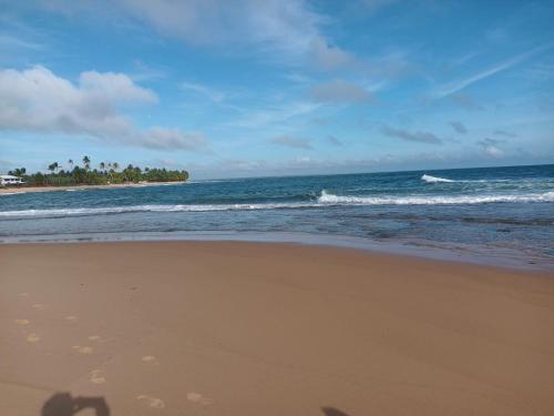 a shadow of a person taking a picture of the ocean at Barra Grande Villa Uluwatu 104 in Barra Grande