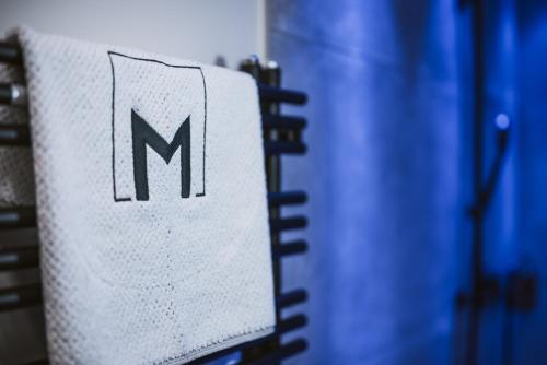 a sign with the letter m on the side of a notebook at Margarethenstein Boutique Hotel in Kaprun