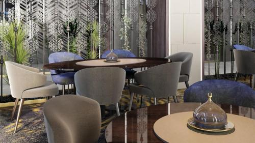 a dining room with a table and chairs at Holiday Inn & Suites - Al Khobar by IHG in Al Khobar