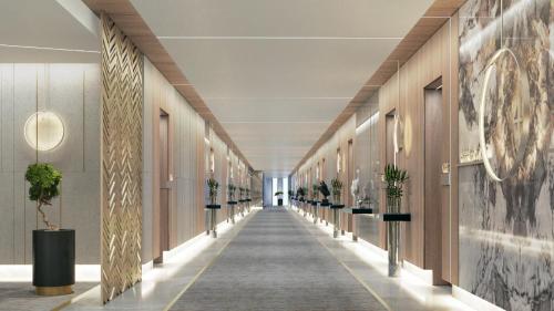 a hallway of a building with potted plants at Holiday Inn & Suites - Al Khobar by IHG in Al Khobar