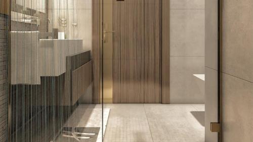 a lobby with a glass door and a staircase at Holiday Inn & Suites - Al Khobar by IHG in Al Khobar