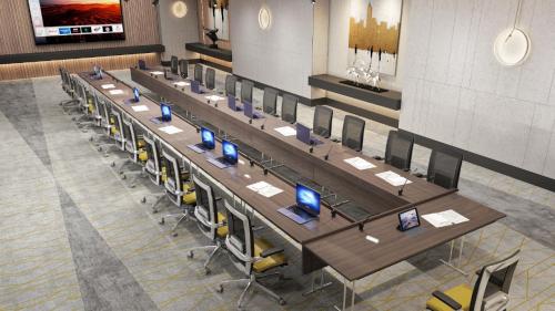 a group of tables with computers on them in a room at Holiday Inn & Suites - Al Khobar by IHG in Al Khobar