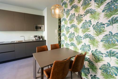 a kitchen and dining room with a table and chairs at AlbaResidence Vico01 in Alba