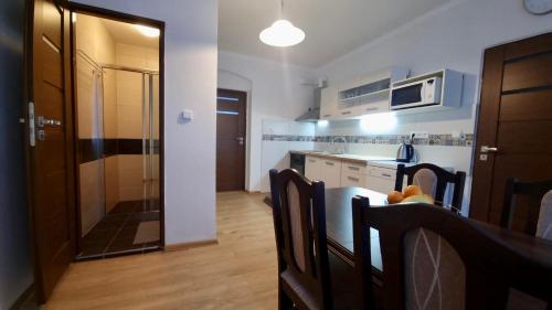 a kitchen with a table and chairs and a microwave at Apartmán v Krušných horách-free parking in Jáchymov