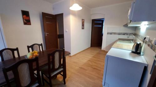 a kitchen and dining room with a table and a white refrigerator at Apartmán v Krušných horách-free parking in Jáchymov
