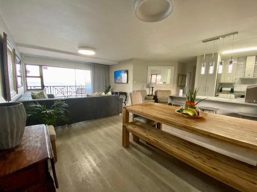 a living room with a table and a couch at Rosebud 4 Beacon Point in Mossel Bay