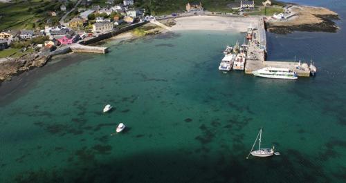 an aerial view of a harbor with boats in the water at Aran Islands Hotel in Kilronan