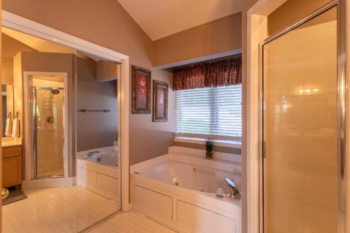 a large bathroom with a tub and a shower at Little Bear Lodge in Blowing Rock