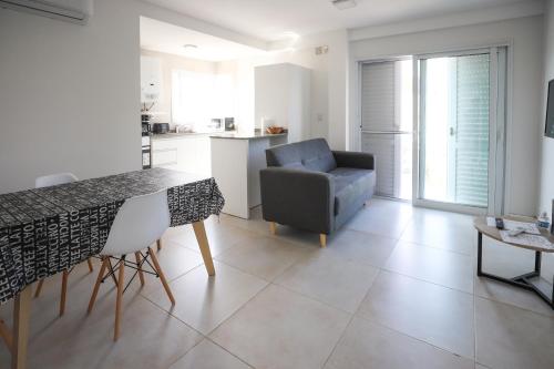 een keuken en een woonkamer met een bank en een tafel bij Departamento de un dormitorio - JUJUY in Santa Fe