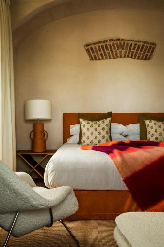 a bedroom with a bed with a red blanket on it at La Dehesa de Don Pedro in Monesterio