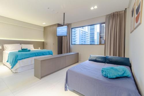 a bedroom with two beds and a large window at Mardisa Design - Luxo e Requinte em Cabo Branco por Carpediem in João Pessoa
