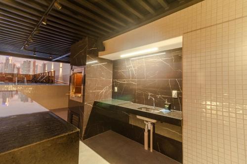 uma casa de banho com um lavatório e um espelho em Mardisa Design - Luxo e Requinte em Cabo Branco por Carpediem em João Pessoa