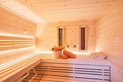 a teddy bear sitting in a wooden sauna at Chiemgauferienwohnungen - Wanderlust und Alpenrose in Unterwössen