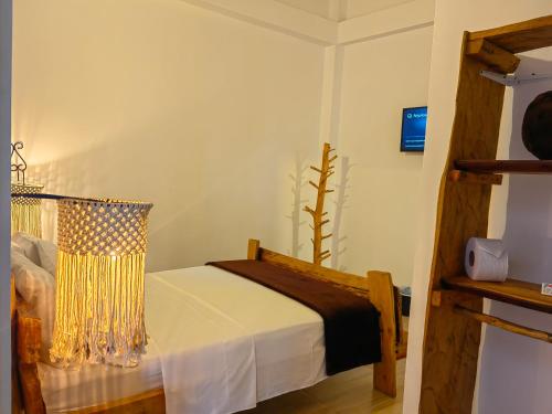 a bedroom with a bed and a tv in a room at Hotel Salento Mirador in Salento