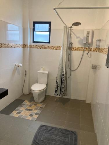 a bathroom with a shower and a toilet in it at Oneandaman Resort in Khao Lak