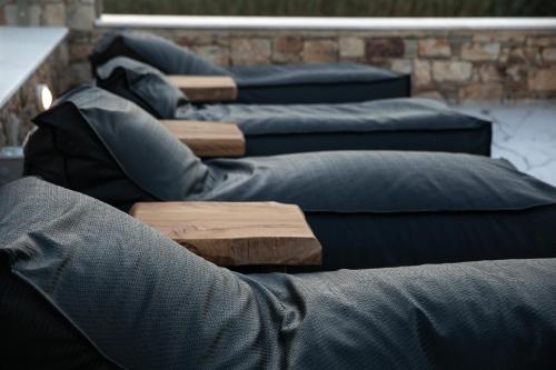 a row of blue pillows sitting next to each other at Naxian green life in Agia Anna Naxos