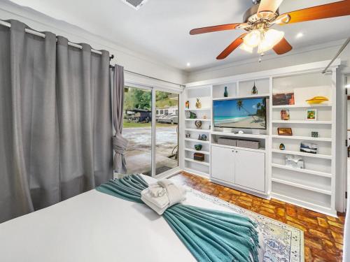 a bedroom with a bed and a ceiling fan at Island Hideout in Charleston