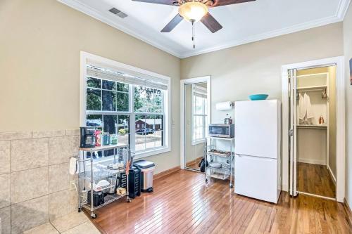 a living room with a white refrigerator and a window at Island Nest in Charleston