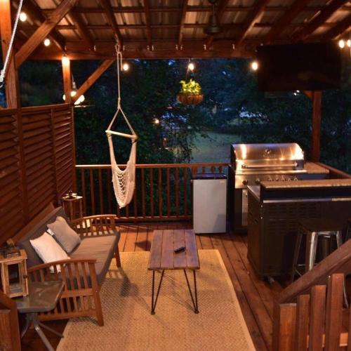 a screened in porch with a hammock and a grill at Island Nest in Charleston
