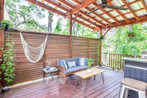 a patio with a hammock on a wooden deck at Island Nest in Charleston