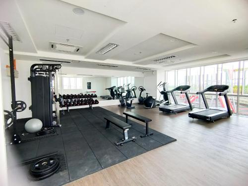 a gym with several treadmills and machines in a room at SiX Staycation in Kuching