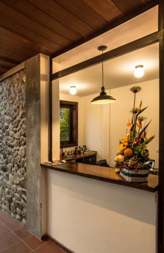 a kitchen with a counter with a stone wall at Villa Salento Boutique Apartments & Spa in Salento