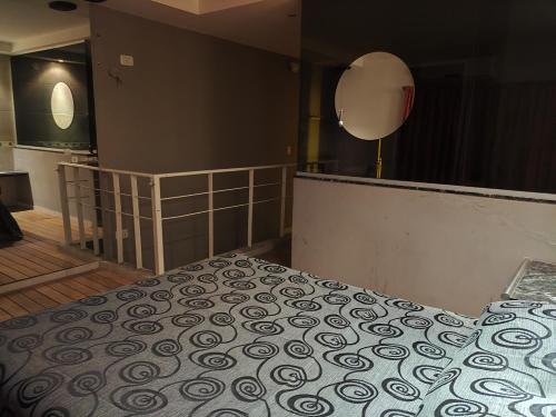 a bedroom with a bed and a mirror on the wall at Hotel Lido in General Rodríguez