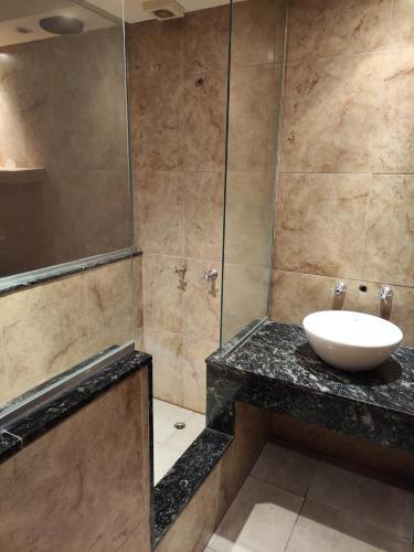 a bathroom with a sink and a shower at Hotel Lido in General Rodríguez