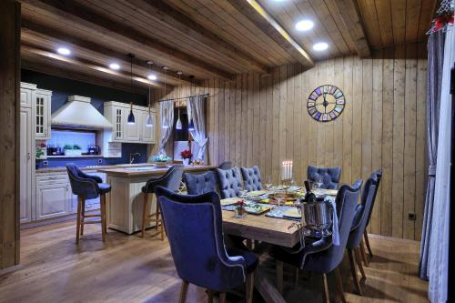 a kitchen and dining room with a table and chairs at Lakeside Hotel Plitvice in Plitvička Jezera