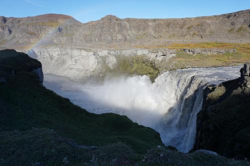 a waterfall on the side of a mountain at Slow Travel Mývatn - Þúfa - Private Homestay in Myvatn